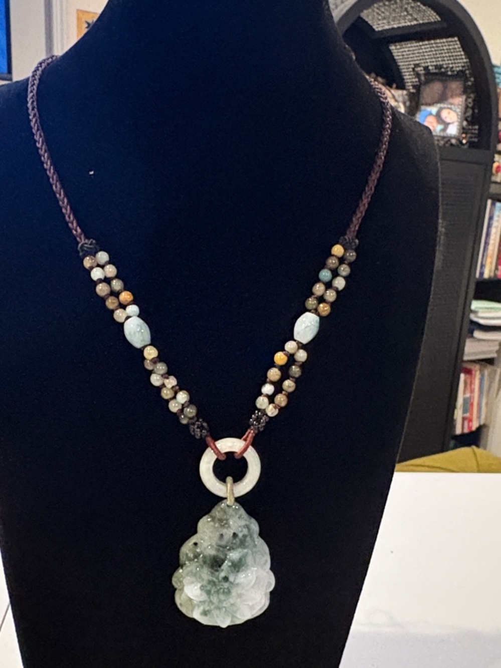 Green Carved Jade Pendant Necklace with Beaded Cord and intricate woven thread.